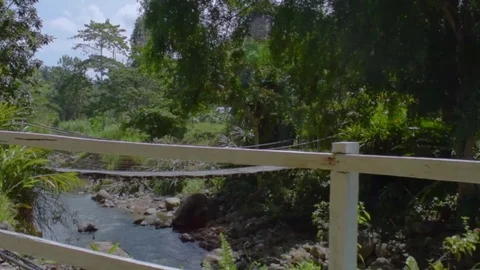 Zoom-in shot of the river seen over the fence Stock Footage 93594394