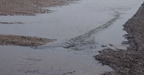 Zoom Shot of small river channels at low tide at Gronant beach Stock Footage 345355729