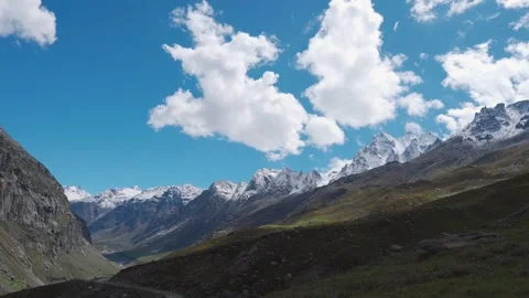 Zoom in shot of snow capped peaks of Himalayan mountains with clouds moving in b Stock Footage 225714964