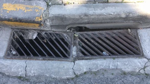 Zoom in Shot of Water flow to Pavement Sewer Stock Footage 102229802