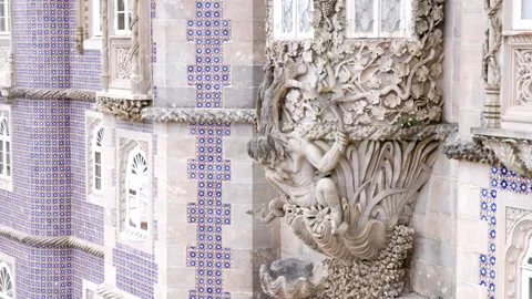Zoom in side view of a merman on a wall at national palace of pena Stock Footage 277126729