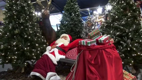 Zoom In on sleeping Santa on bench Stock Footage 82429901