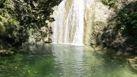 Zoom in of small waterfall streaming down side of mountain in Jamaica Stock Footage 125094843