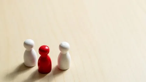Zoom in social dynamics three figures in conflict minimalist setting close-up Stock Footage 309850753