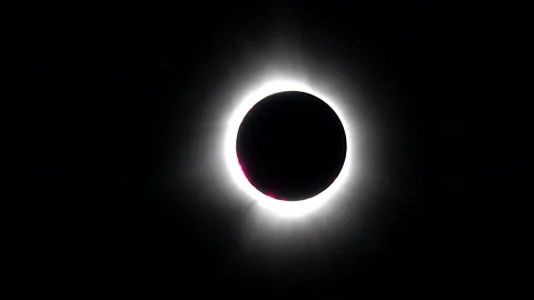 Zoom-in of solar eclipse with deep red Baily's beads visible on edge of Stock Footage 272406136
