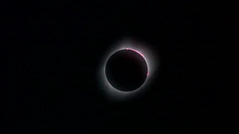 Zoom-in on solar eclipse showing prominences, corona and diamond ring Stock Footage 274039443