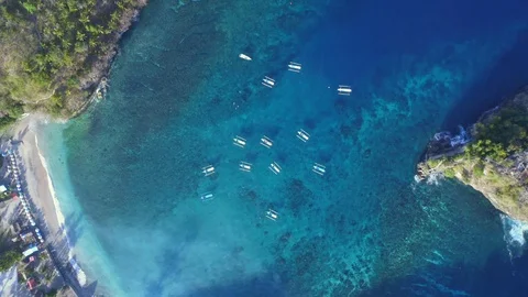 Zoom in Spinning Overhead Drone Shot Jukung Boats at Crystal Bay at Nusa Stock Footage 113894530