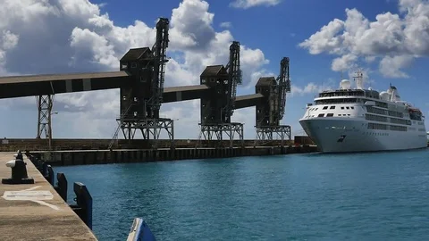 ZOOM Sugar loading conveyors and cruise ship in harbor Georgetown Barbados Stock Footage 73525334