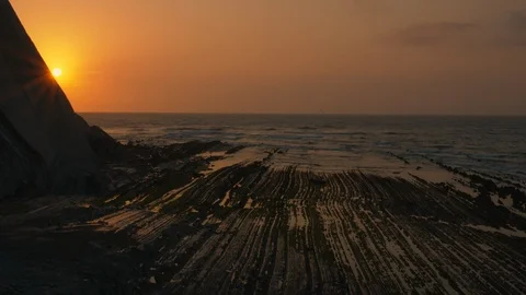 Zoom in sun hides behind mountain at sunset Stock Footage 112295694