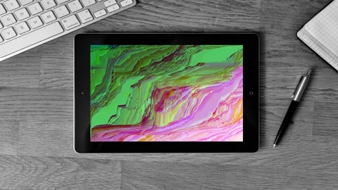 Zoom on a tablet on a desk work with GLITCH art pixels waves on screen Stock Footage 119294286