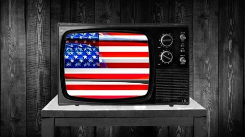 Zoom then fixed shot on an old retro television in 70's 80's vintage style wi Stock Footage 136884706