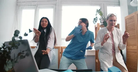Zoom in on three fun diverse happy scientist female doctors dancing celebrating Stock Footage 152236963