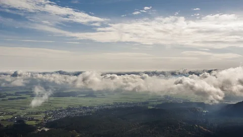 Zoom in time lapse of clouds forming above countryside field Stock Footage 128955377