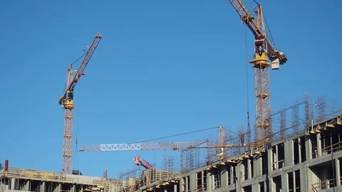 Zoom Time lapse tilt shift builders and industrial cranes work on construction Stock Footage 129663436