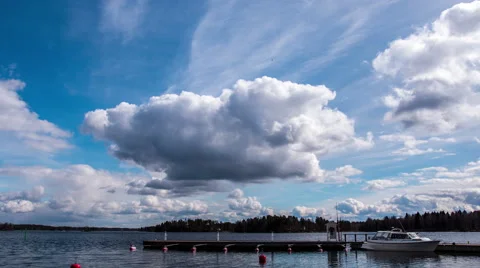 Zoom timelapse of clouds moving over a lake and pier Stock Footage 49690001