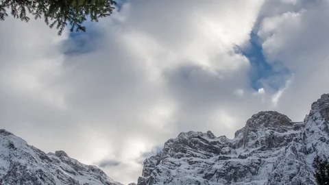 Zoom-in timelapse shot of clouds running over snowy peaks of the Julian Alps Stock Footage 89836157