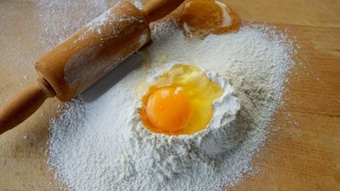 Zoom to the uncooked, raw egg on table top. Video stock 104531911