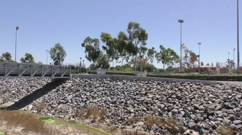Zoom into US Flag by bike path with rocked in wash. Stock Footage 67558434