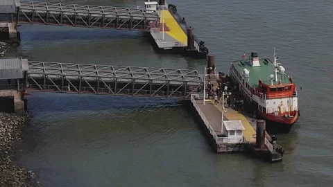 Zoom view of people exiting a large ferry boat on River Tagus at Cais do Sodre Stock Footage 236920535