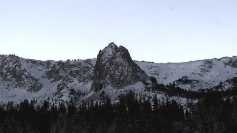 Zoom view of snow and ice on mountains and a lake full of birds, in Mammoth.. Stock Footage 72425015