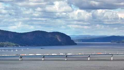 Zoom view of Traffic crossing Hudson River with mountains in background Stock Footage 316905288