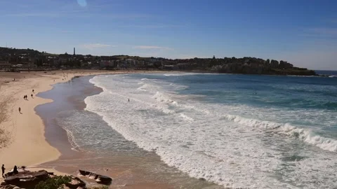 Zoom in to waves at Bondi beach in Sydney and surfers in 4k video. Stock Footage 135497798