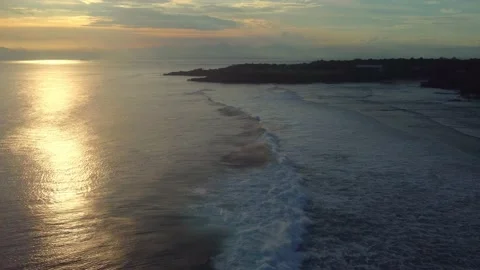 Zoom in: Waves splashing on the beach by sunset (Bali - Indonesia) Stock Footage 202134143