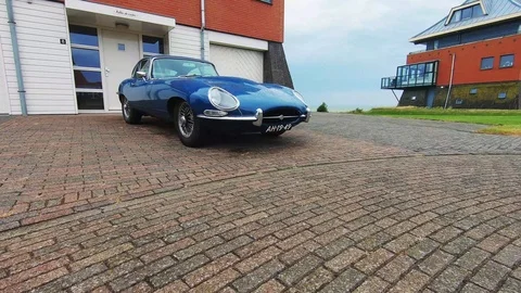 Zoom in to the wheel of the Jaguar E-type 4.2 (1966) Stock Footage