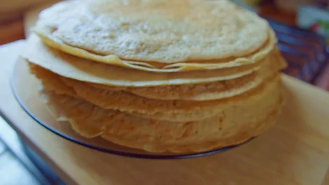 Zoom on yellow delicious pancake stack on glass plate. Slowmo. Side view. Stock Footage 128701570