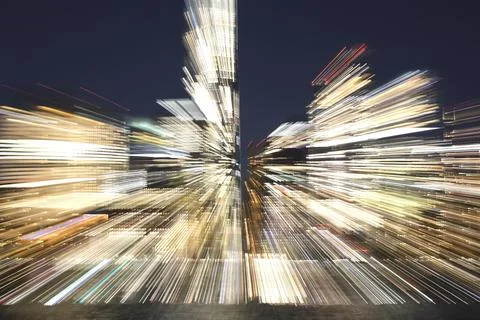 Zoomed effect with bright light trails of city lights night background Stock Photos
