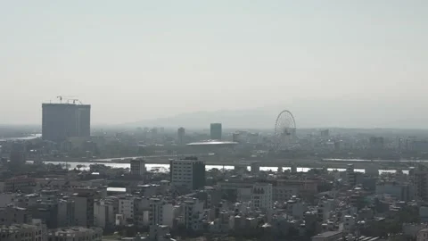 Zoomed in Elevated Pan Over Da Nang, Vietnam Cityscape With Hazy Mountains in Video stock 328798175