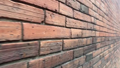 Zoomed-in old orange brick wall with visible rough textures Stock Footage 314098610
