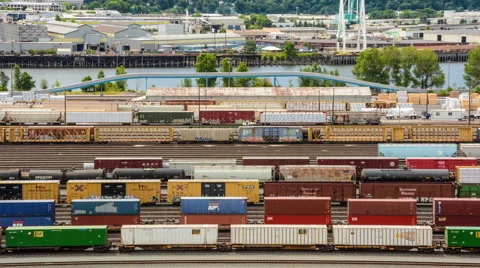 Zoomed in Time Lapse of Train Yard with River Background Stock Footage 40358725