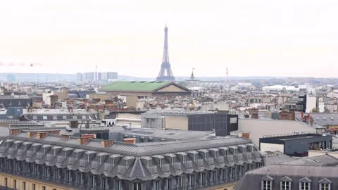 Zoomed-in view of Eiffel Tower and Paris rooftops Stock Footage 314040888