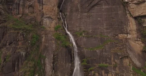 Zooming away from a tall thin waterfall Stock Footage 81003288