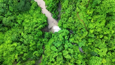 Zooming in on a breathtaking waterfall cascading down the mountainside. The crys Stock Footage 287765290