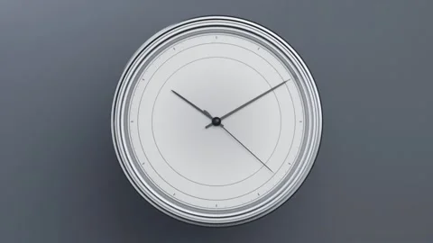 Zooming camera showing round analog wall clock centered on grey plane, with Stock Footage 337505107
