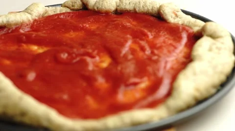 Zooming focus in on pizza base with tomato flavored sauce, shallow depth of f Video stock 68936381