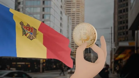 Zooming in on golden bitcoin held by hand, with a waving Moldova flag Video stock 296158366