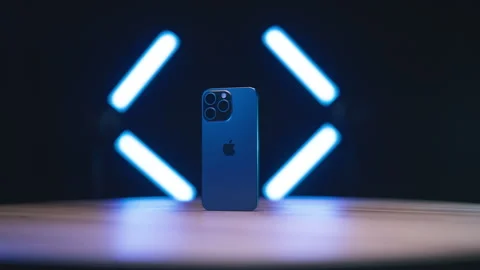 Zooming on iPhone 15 Pro Max surrounded with neon lights 4K Video stock 258261933