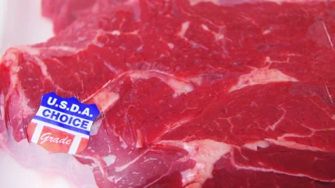 Zooming in on meat in plastic storebought Chuck roast from Costco USDA choice Stock-Footage 194138405