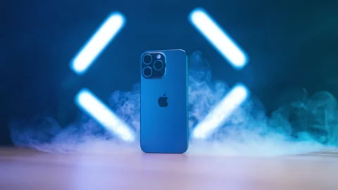 Zooming on new iPhone 15 Pro Max blasted with smoke studio shot 4K Video stock 258265588
