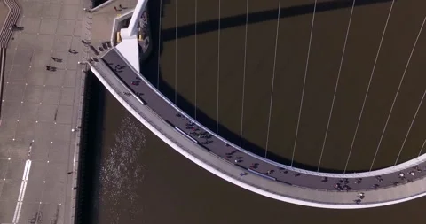 Zooming out of Gateshead Millenium Bridge walkway to full view Stock Footage 159159015