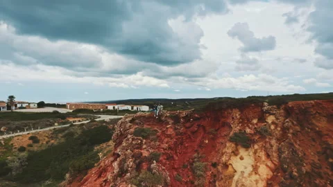 Zooming out shot by drone featuring two men on top of the cliffs Stock Footage 203597210