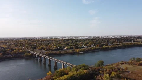 Zooming Out on Train Bridge Over River During Autumn Stock Footage 140974457