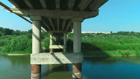 Zooming out under the bridge passing bridge constructions. 4K. Stock Footage 113291466
