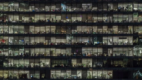 Zooming out view of office windows with working people Stock Footage 123007983