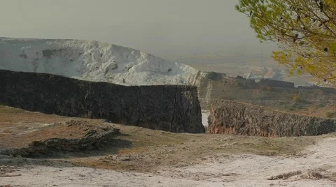 Zooming a pine tree with an ancient wall and travertines in a distance Stock Footage 61208252