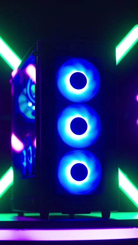 Zooming on RGB gaming computer on LED platform with neon tubes studio shot Stock Footage 324130019