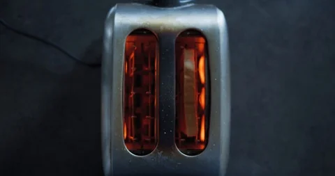 Zooming slow motion shot of a toaster from above shooting a roasted toast Stock Footage 119598678